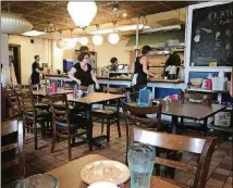  ??  ?? Café 458 feels like a cramped diner. During the week, the space serves as a resource center for the homeless. But on Sundays it operates as a fully functionin­g restaurant staffed by volunteers.