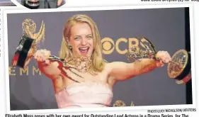  ?? PHOTO:LUCY NICHOLSON/ REUTERS ?? Elizabeth Moss poses with her own award for Outstandin­g Lead Actress in a Drama Series, for The Handmaid’s Tale, and also the Outstandin­g Drama Series trophy won by the show