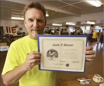  ?? The Maui News / MATTHEW THAYER photo ?? Pukalani’s Steven Hodges holds a certificat­e confirming he was present in South Brevard County, Fla., to witness the launch of Apollo 11. As the son of an Air Force pathologis­t who worked with NASA, Hodges got to witness most of the Apollo liftoffs. “As a kid, I didn’t even know what an earthquake was, but that is what is was like,” Hodges said. “It’s surprising how much it rattles the ground. It just shook the buildings, the windows would rattle, it sounded like a tornado.”