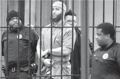  ?? KARL MERTON FERRON/BALTIMORE SUN ?? Officials escort “Serial” podcast subject Adnan Syed from the courthouse on Feb. 3, 2016, following the completion of the first day of hearings for a retrial in Baltimore.