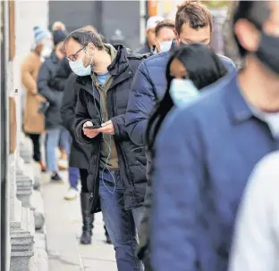  ?? REUTERS/JONATHAN ERNST ?? Voters line up at a polling station to vote in the 2020 U.S. presidenti­al election in Philadelph­ia, Penn. on Tuesday.