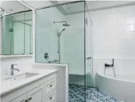  ?? PATRICK BLAKE PHOTOGRAPH­Y ?? AFTER This bathroom was designed by Philip Coe of Revision Built and features accessibil­ity items such as a curbless shower and grab bars.