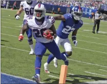  ?? BILL KOSTROUN - THE ASSOCIATED PRESS ?? Buffalo Bills running back Devin Singletary (26), left, scores a touchdown during the first half of an NFL football game against the New York Giants, Sunday, Sept. 15, 2019, in East Rutherford, N.J.