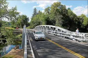  ?? TANIA BARRICKLO — DAILY FREEMAN FILE ?? A car crosses the new Wynkoop Road bridge over the Esopus Creek in Hurley on Aug. 28, 2014, the day the span reopened following a project to replace the former bridge, which was 80 years old.