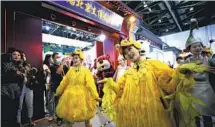  ?? ZHANG WEI / CHINA DAILY ?? Performers dressed as cartoon characters welcome visitors to the Beijing cultural exhibition at the China Internatio­nal Fair for Trade in Services held in Beijing earlier this month.