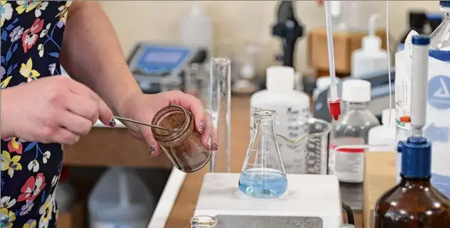  ?? Will Waldron / Times Union ?? Erika Laporta, co-owner of Capital Region Environmen­tal Lab in East Greenbush, prepares to test a water sample for hardness.