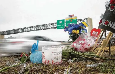  ?? Jon Shapley / Staff photograph­er ?? Traffic passes by a memorial at the site of a car meet held Sunday, when authoritie­s said a crash at a street takeover killed three people. The crash was the deadliest incident since street takeovers gained popularity in the area over the past few years.