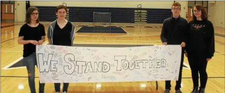  ?? BRADY TUCKER - DIGITAL FIRST MEDIA ?? Kutztown High School Walkout student organizers hold a signed banner that will be sent to Marjory Stoneman Douglas High School in Parkland, Florida. In picture, from left to right, Olivia Sica, Julia Mace, Samuel Arnold, and Hunter Willow-Jones.