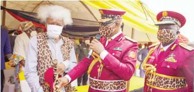  ??  ?? Governor Dapo Abiodun of Ogun State (middle) presents a Staff of Office to Noble Laurel, Prof. Wole Soyinka (left) as Super Marshall of Ogun State Security Network, otherwise known as Amotekun Corps, during the inaugurati­on of the Corps, some patrol vehicles and motorbikes in Abeokuta yesterday. With them is the Corps’ Commander, Mr David Akinremi, a retired Commission­er of Police.