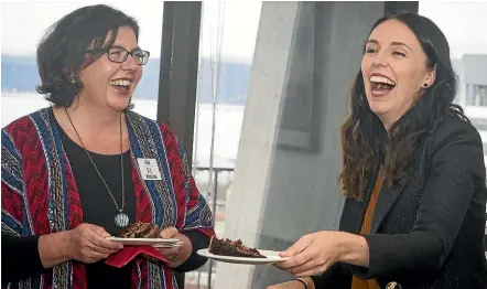  ?? ROSA WOODS/STUFF ?? Education Ministry support worker Jacoline Brink shares a slice of cake with Prime Minister Jacinda Ardern yesterday to celebrate signing a pay equity settlement.