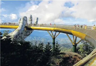  ?? Picture: LINH PHAM/AFP ?? TOURIST MAGNET: Visitors walk along the 150m-long Cau Vang (Golden Bridge) in the Ba Na Hills near Danang, Vietnam