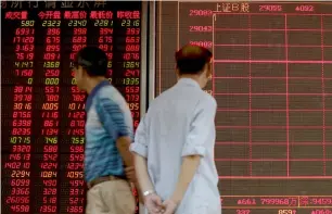  ?? — AP ?? People monitoring stock prices at a brokerage house in Beijing on Monday. Asian stock markets fell and oil prices gave up some of their gains after Chinese regulators freed up extra money for bank lending amid a trade dispute with the US.