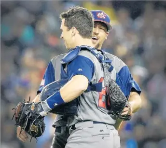  ?? Allen J. Schaben Los Angeles Times ?? RELIEVER Luke Gregerson savors the moment with catcher Buster Posey after striking out Japan’s Nobuhiro Matsuda to nail down Team USA’s 2-1 victory and a ticket to the World Baseball Classic final.