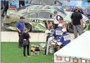  ?? Mike McCarn / The Associated Press ?? Emergency personnel assist driver Kyle Busch after Sunday’s NASCAR Cup Series race at Charlotte Motor Speedway in Concord, N.C.