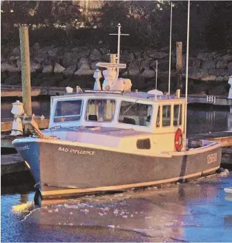  ?? STAFF PHOTO BY STUART CAHILL ?? CHILLING: Jeff Viamari was working on the dock near his boat Bad Influence, above, when he slipped into the water. Rescue vehicles, right, photograph­ed by Enid Bonilla.