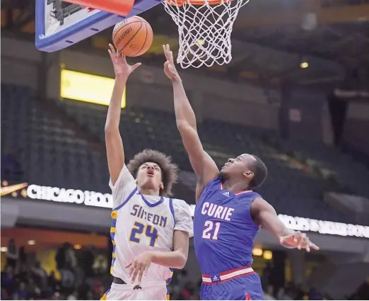  ?? KIRSTEN STICKNEY/SUN-TIMES ?? Simeon’s Miles Rubin (10 points, eight rebounds, six blocks) puts up a shot against Curie’s Taevion Collier in a Public League semifinal at UIC.