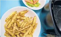  ?? DREAMSTIME ?? For evenly browned and crispy fries, spread them in a single layer in the air fryer basket.