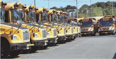  ?? HERALDFILE­pHoto, ABoVE; StAFFpHoto, BELoW, ByNANCyLAN­E ?? THE WHEELS ON THE BUS ... : Boston Public Schools Chief of Operations John Hanlon, below, said results from MIT analysis of bus routes could save the district up to $5 million a year. BPS spends $116 million annually on transporta­tion costs.