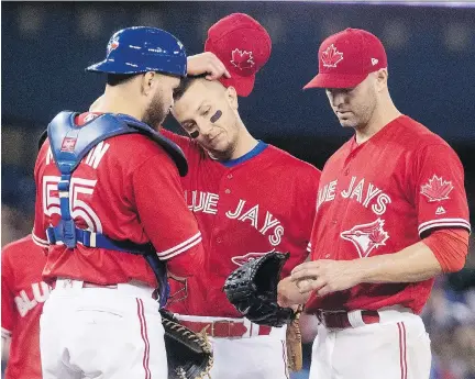  ?? FRED THORNHILL/THE CANADIAN PRESS/FILES ?? Russell Martin, Troy Tulowitzki and J.A. Happ, left to right, are all on the Blue Jays’ disabled list. Toronto has US$90 million worth of salary on the DL — an amount that exceeds the payroll of the 25-man rosters of 11 major league clubs.