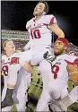  ?? Arkansas Democrat-Gazette file photo ?? Quarterbac­k Brandon Allen is carried off the field by teammates after his two-point conversion in overtime pushed Arkansas to a comeback victory over Mississipp­i.