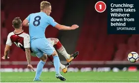  ?? SPORTIMAGE ?? Crunching: Smith takes Wilshere down from behind