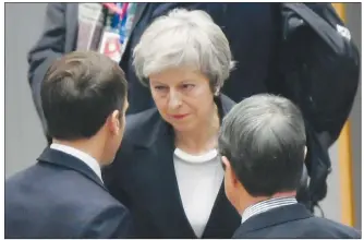  ?? AP PHOTO ?? British Prime Minister Theresa May speaks with French President Emmanuel Macron during a round table meeting at an EU summit in Brussels on Thursday. EU leaders gathered Thursday for a two-day summit which will centre on the Brexit negotiatio­ns.