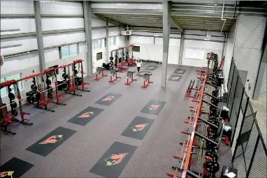  ?? PHOTOS BY MARK HUMPHREY ENTERPRISE-LEADER ?? Farmington head football coach Mike Adams inspects the spacious weight-room located within the fieldhouse at Cardinal Stadium. Adams appreciate­s the facility, which he anticipate­s will accelerate progress for the football program while competing in the tough 5A West Conference.