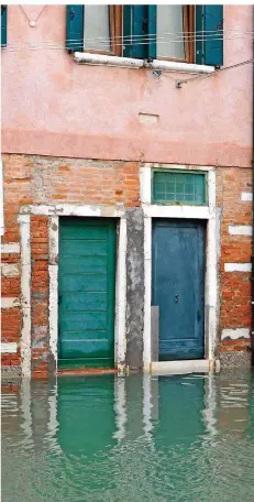  ?? FOTO: DORIS DÖPKE ?? Vorbild Venedig: Eine Art Schott schützt die Tür rechts. Eine simple Konstrukti­on: In Schienen auf beiden Seiten wird von oben eine Edelstahlp­latte eingeschob­en, die das Eindringen von Wasser verhindert. Bei höherem Wasserstan­d lassen sich auch mehrere...