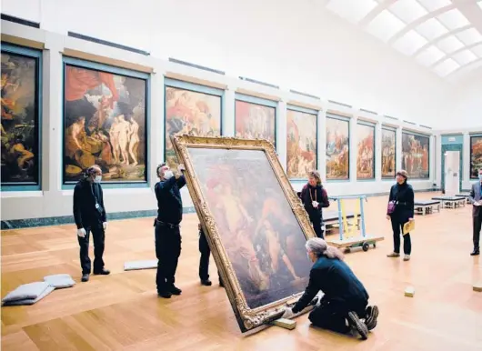  ?? DMITRY KOSTYUKOV/THE NEW YORK TIMES PHOTOS ?? Anthony van Dyck’s “Venus Asks Vulcan to Cast Arms for Her Son Aeneas” is moved by workers in January at the Louvre in Paris.