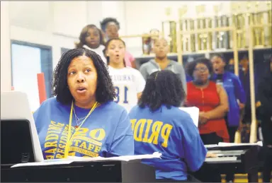  ?? Ned Gerard / Hearst Connecticu­t Media ?? With members of one of her classes reflected in a mirror behind her, Sheena Graham leads choir practice at Harding High School in Bridgeport on Friday. Graham has been selected as a finalist for the 2019 Connecticu­t Teacher of the Year.