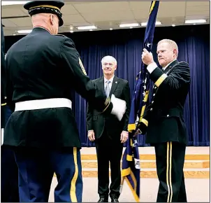  ?? Arkansas Democrat-Gazette/THOMAS METTHE ?? Maj. Gen. Kendall Penn (right) passes the Arkansas National Guard Colors to Command Sgt. Maj. Steven Veazey after receiving the colors from Gov. Asa Hutchinson during an Arkansas National Guard change of command ceremony Saturday at Camp Robinson in North Little Rock. More photos are available at www.arkansason­line.com/811command/