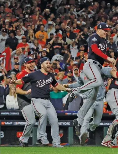  ?? AP ?? The Nationals celebrate after winning the World Series for the first time in the history of the franchise Wednesday against the Astros in Houston. It is the first baseball title for the city of Washington since 1924.