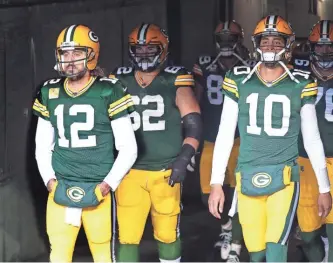  ?? MIKE DE SISTI/JOURNAL SENTINEL ?? If the Packers keep quarterbac­k Aaron Rodgers (left) for next season, they might be forced to trade 2020 first-round pick Jordan Love.