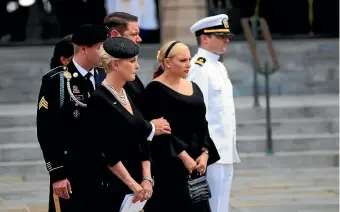  ?? AP ?? The family of Senator John McCain, from left, Jimmy McCain, Cindy McCain, Ben Domenech and his wife Meghan McCain, and Jack McCain watch as the casket is placed into the hearse following a memorial service at the Washington National Cathedral in Washington.