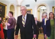  ?? AP PHOTO/J. SCOTT APPLEWHITE ?? Senate Minority Leader Mitch McConnell, R-Ky., joined at right by Sen. Joni Ernst, R-Iowa, arrives to meet with reporters after a weekly strategy luncheon at the Capitol in Washington on Tuesday.