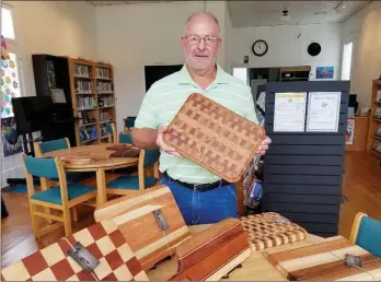  ?? SUBMITTED ?? Steve Shock, a retired teacher and coach in the Vilonia School District, stands in the El Paso Community Library with his handmade wooden cutting boards. His work is on display at the library during September as part of the Artist of the Month program.