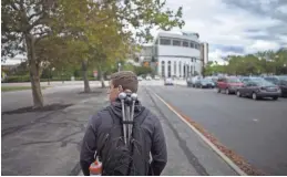  ?? ?? Carrying a backpack full of batons, Austin Bowman walks to rehearsal.