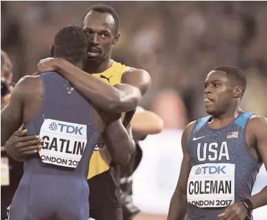  ?? RICARDO MAKYN/MULTIMEDIA PHOTO EDITOR ?? Usain Bolt hugs Justin Gatlin while Christian Coleman looks on.