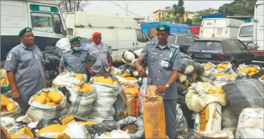  ??  ?? The Acting Customs Area Controller, Federal Operations Unit, Zone A, Usman Yahaya ( middle) parading the intercepte­d contraband­s in Lagos.