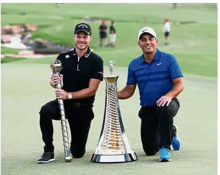  ??  ?? Triumphant: Danny Willett (left) poses with the DP World Tour trophy next to Francesco Molinari of Italy and his Race to Dubai silverware after the final round of the World Tour Championsh­ip tournament at the Jumeirah Golf Estates golf course in Dubai on Sunday. — AFP