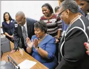  ?? BOB ANDRES /BANDRES@AJC.COM ?? Stacey Abrams, who qualified to run for governor, is joined by her parents, who drove in from Hattiesbur­g, Miss., to surprise her.