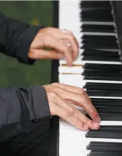  ?? Paul Chinn / The Chronicle ?? Michael Smith, who arrived early to avoid the crowds, plays one of the pianos in the garden.