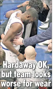  ?? Bill Kostroun ?? DIE HARD’: Tim Hardaway Jr. is helped off the floor after getting kicked by Giannis Antetokoun­mpo in the same shin that caused him to miss time earlier this season.