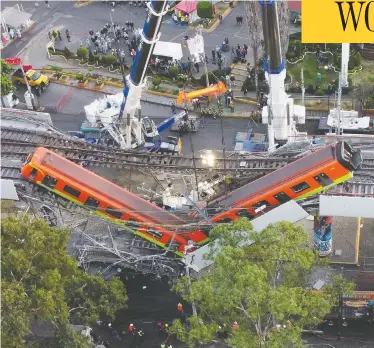  ?? CARLOS JASSO / REUTERS ?? A view of the damage caused after a railway overpass and train collapsed onto a road in Mexico City on Tuesday.