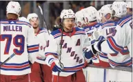  ?? Winslow Townson / Associated Press ?? The Rangers’ Artemi Panarin is congratula­ted at the bench after scoring against the Bruins on Friday.