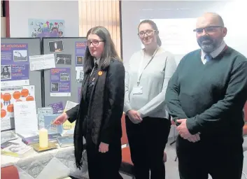  ??  ?? Tribute Second year pupil Paige Whitehouse had the honour of lighting the BOOKies group’s candle