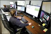  ?? NWA Democrat-Gazette/DAVID GOTTSCHALK ?? Felicia Young (right) and Reva McGourty, both dispatcher­s with Central EMS, answer calls Tuesday in the dispatch area of Station One in Fayettevil­le.