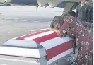  ??  ?? >
Myeshia Johnson cries over the casket of her husband La David