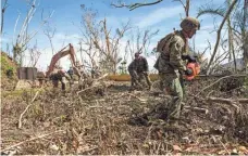  ?? U.S. NAVY VIA GETTY IMAGES ?? U.S. Marines have joined civilians to clear roads still blocked by debris more than a week after Maria.