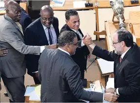  ?? MULTIMEDIA PHOTO EDITOR. RICARDO MAKYN ?? Opposition Spokesman on Finance Mark Golding being congratula­ted by fellow parliament­arians after delivering his maiden presentati­on to the Budget Debate in Gordon House on Tuesday.